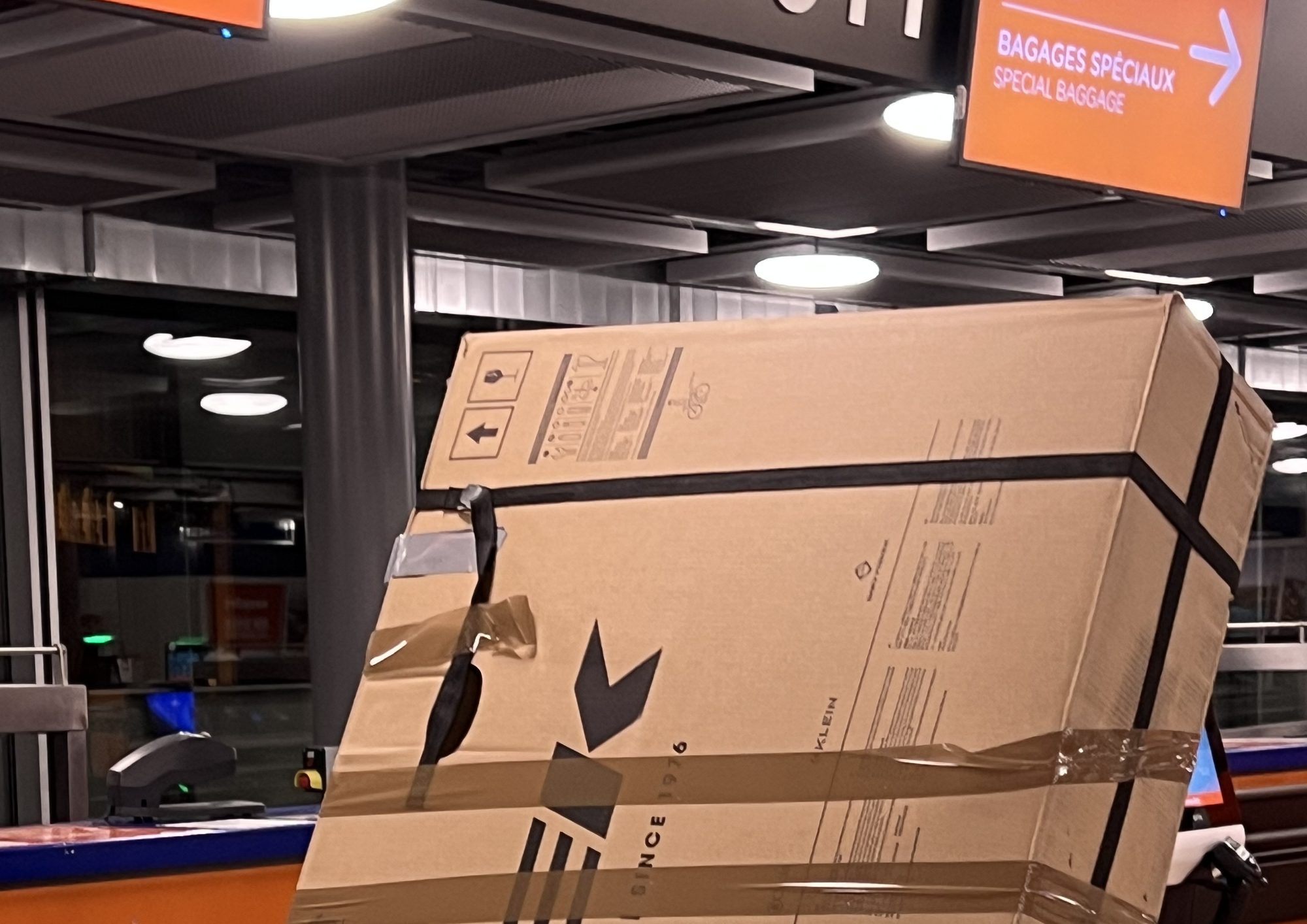A mountain bike packed in its box at the airport's special baggage counter, flying with your MTB with Exoride